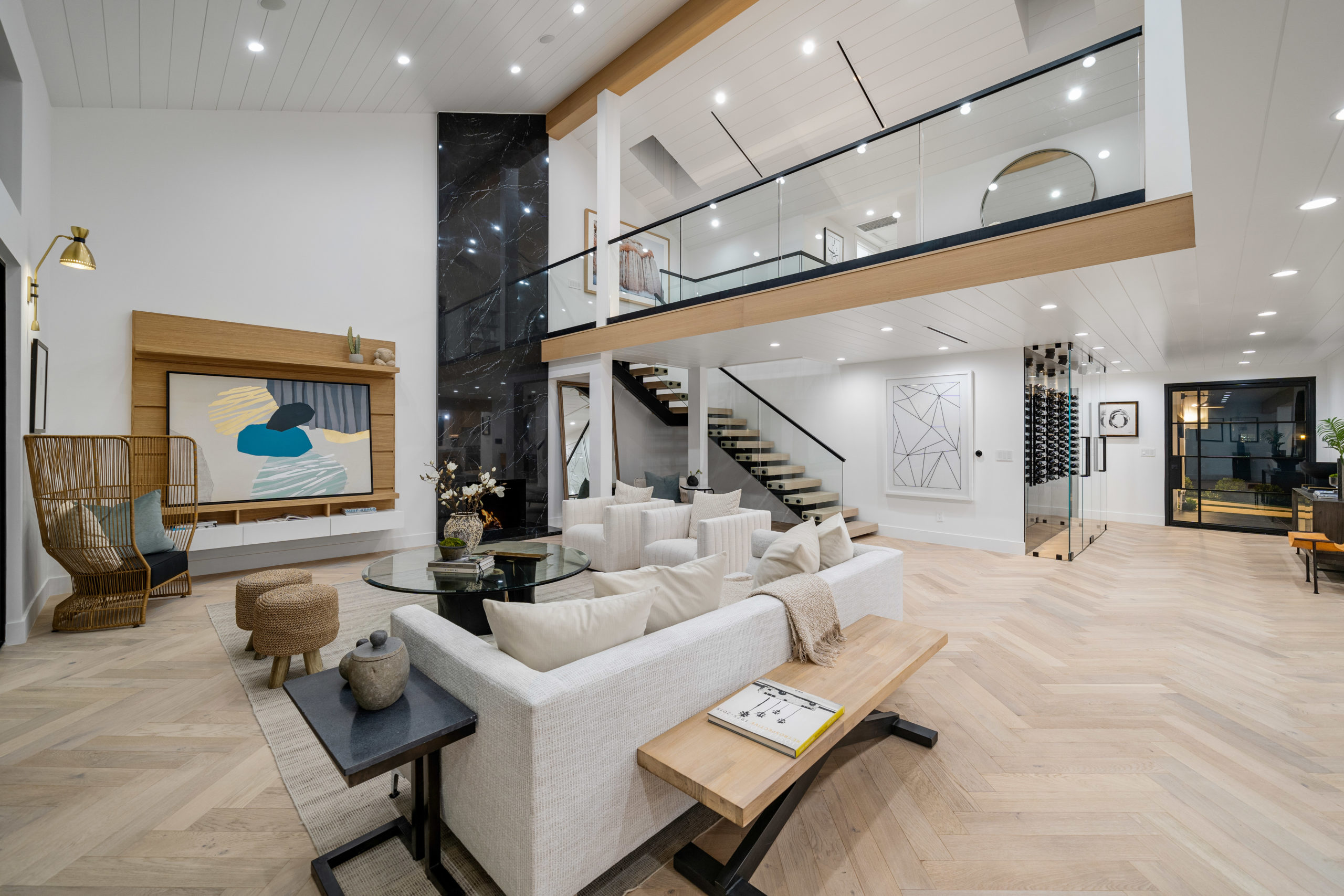 Living room with herringbone hardwood flooring and an open staircase, a completed Glamour Flooring project