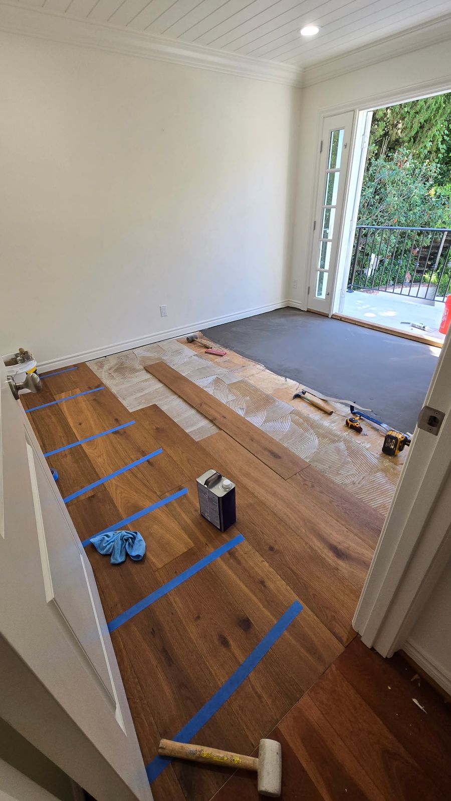 French oak engineered hardwood planks being installed over adhesive in Woodland Hills