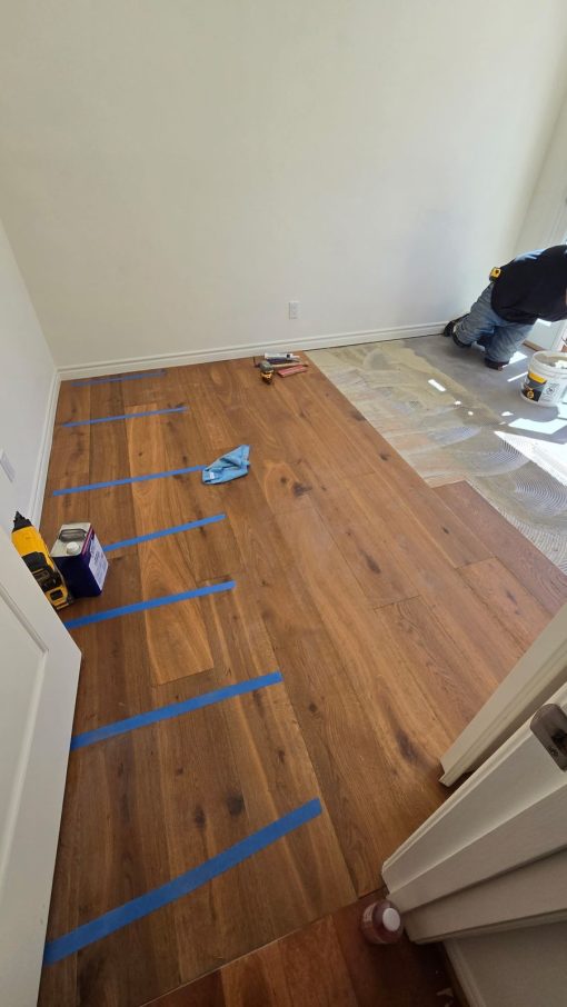 Glamour Flooring installer setting French oak engineered planks in a Woodland Hills home