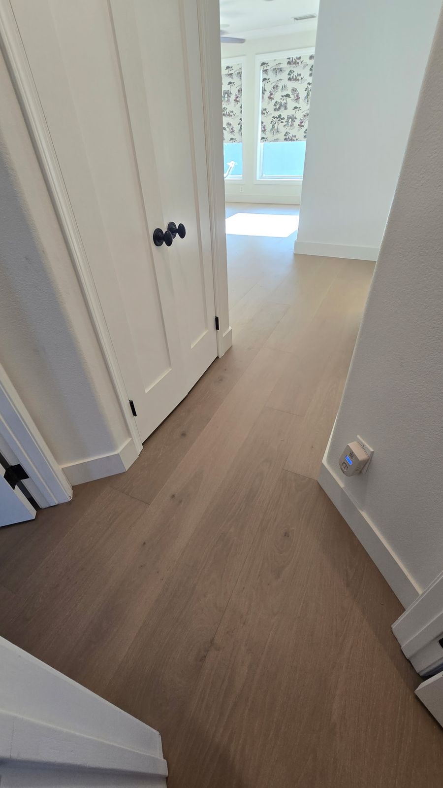 European oak hardwood floor running from a hallway into a bedroom in Los Angeles