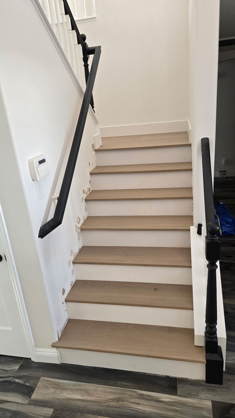 Hardwood stair treads with stair noses and white painted risers on a Los Angeles staircase