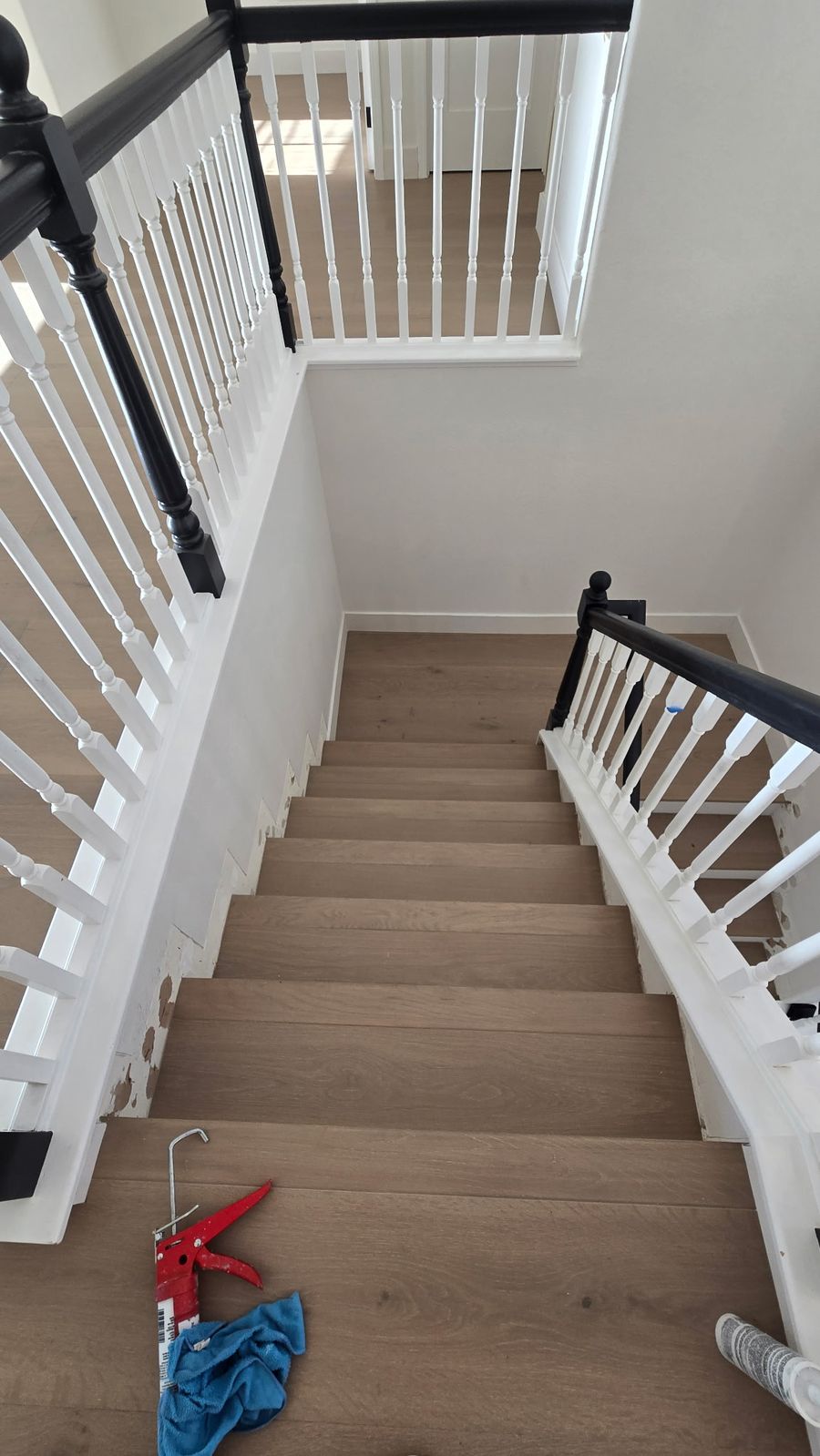 Hardwood staircase with stair nose treads seen from the upstairs landing in Los Angeles