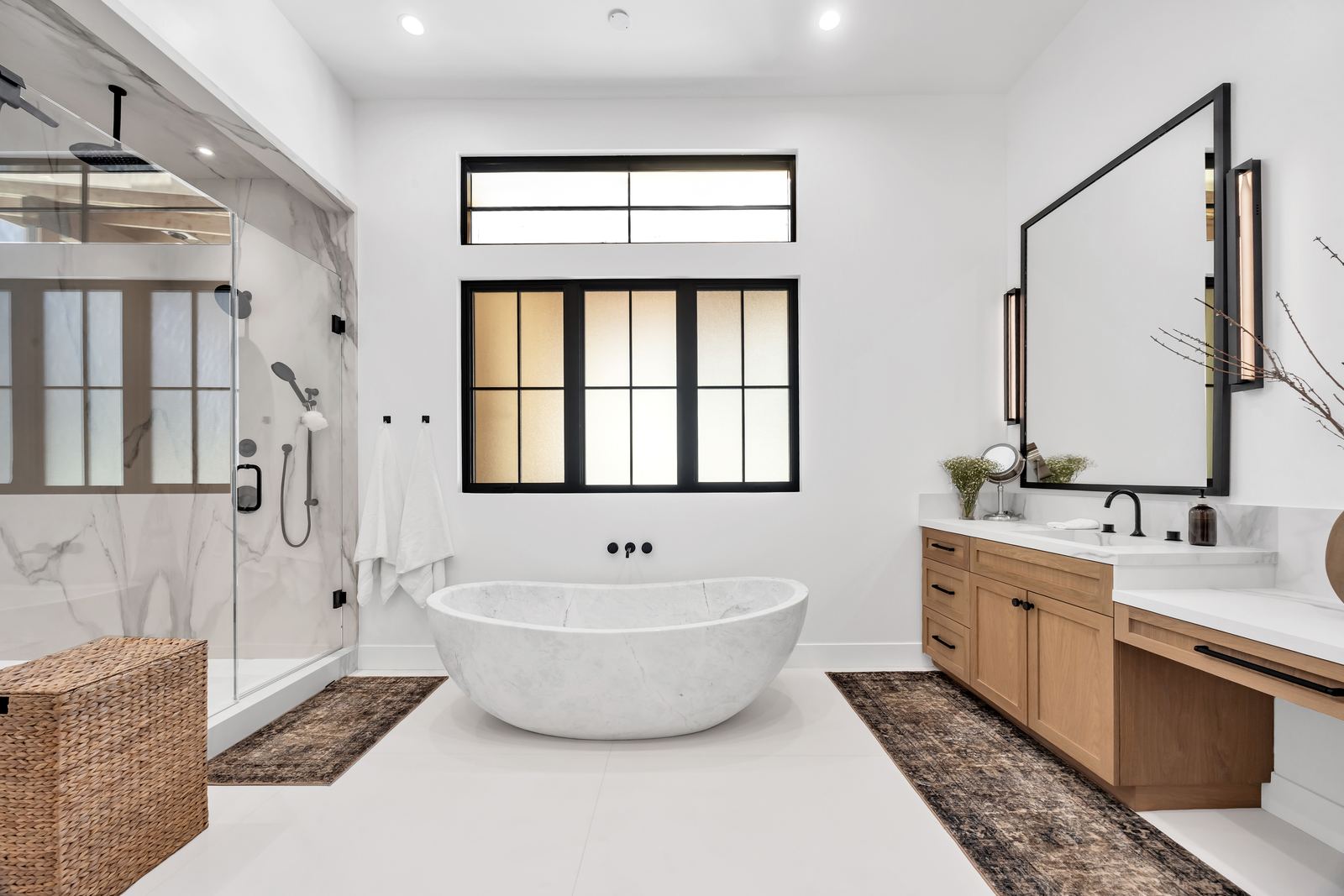 Luxury bathroom remodel with marble walk-in shower, stone soaking tub and white oak vanity