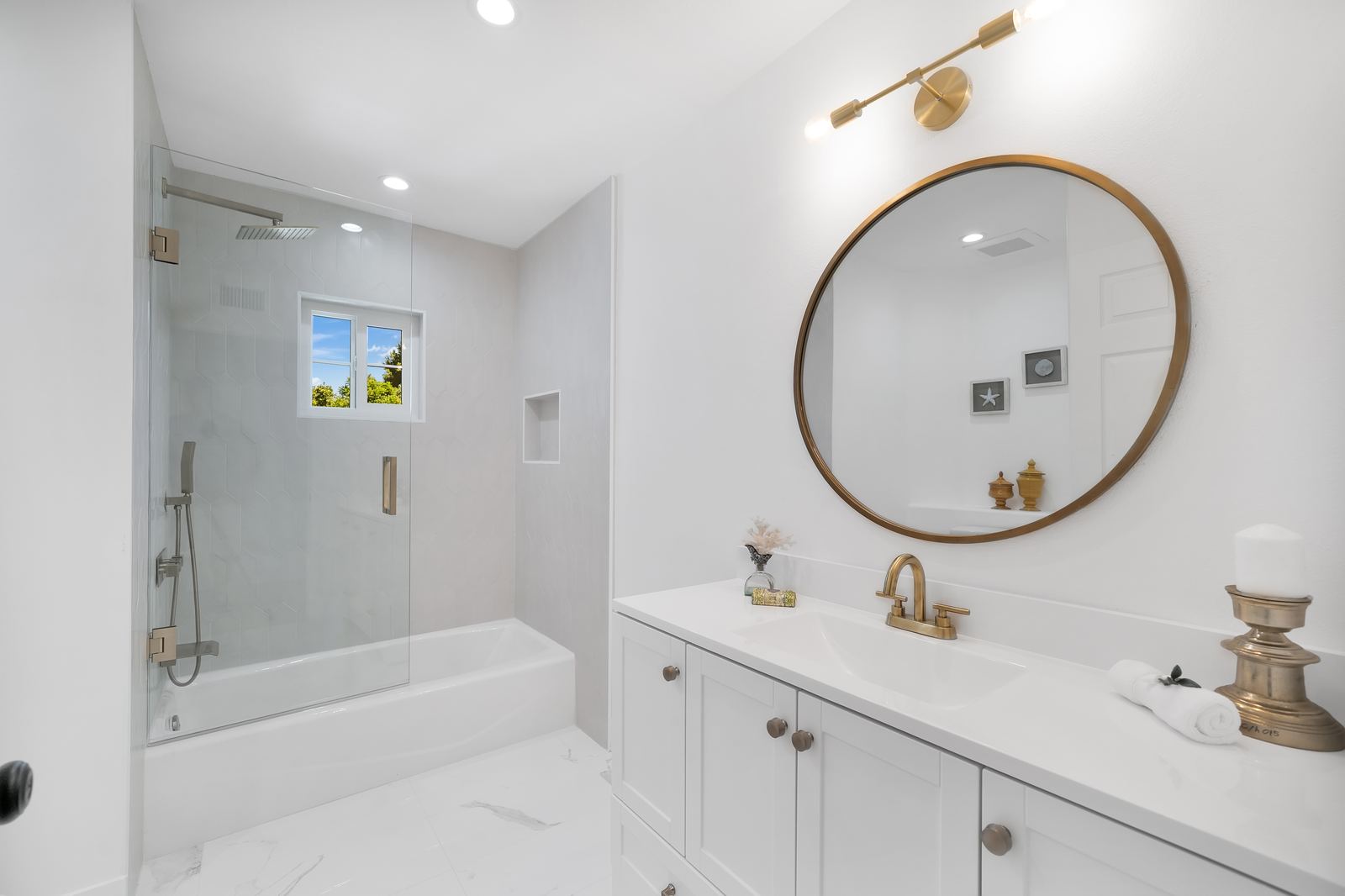Tub and shower remodel with glass door, white picket tile and white shaker vanity