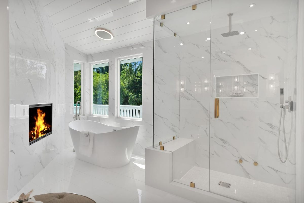 Walk-in shower remodel with marble-look porcelain walls, frameless glass and built-in bench