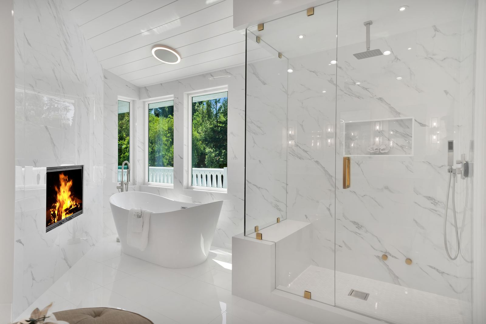 Walk-in shower remodel with marble-look porcelain walls, frameless glass and built-in bench