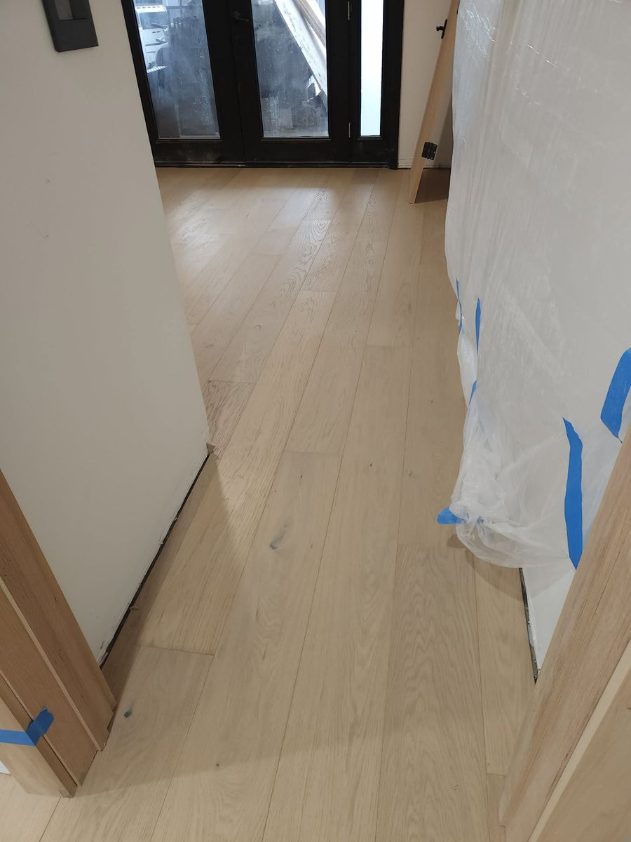 Wide-plank oak hardwood flooring at the front entry of a Calabasas home