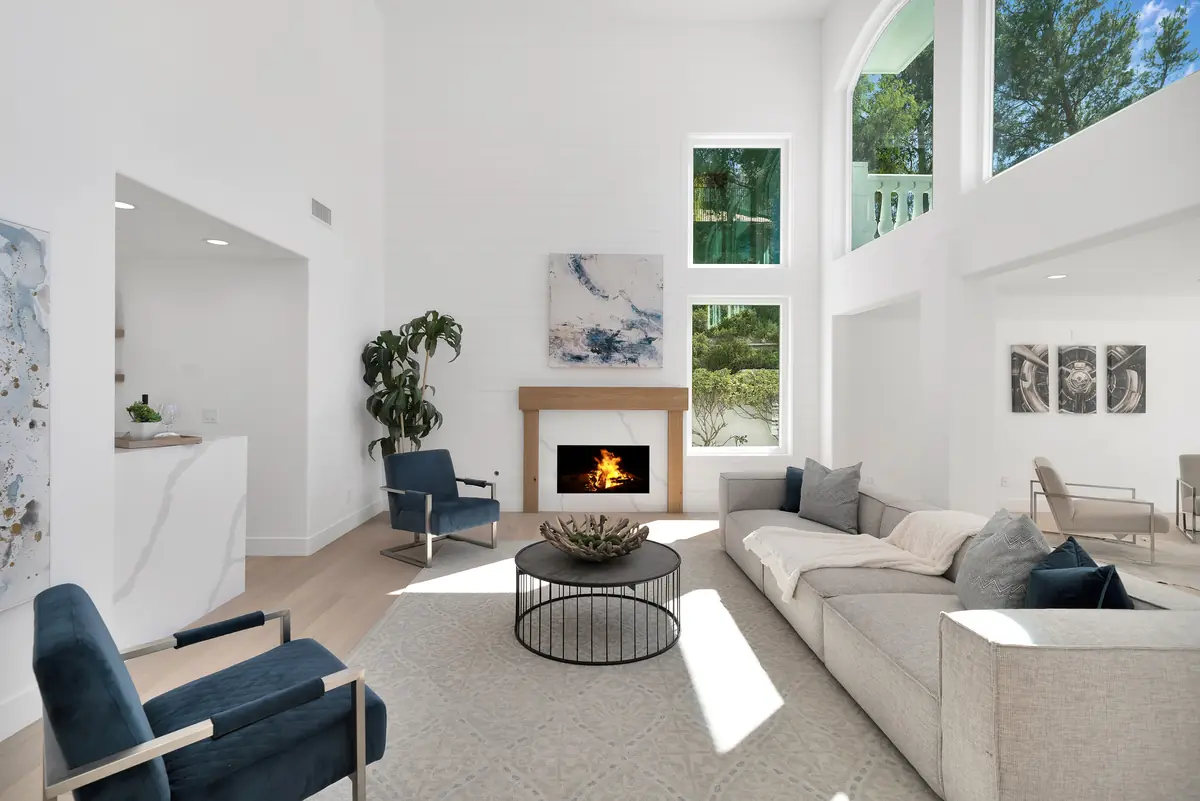 Living room with light wood floors and a fireplace, a Glamour Flooring project