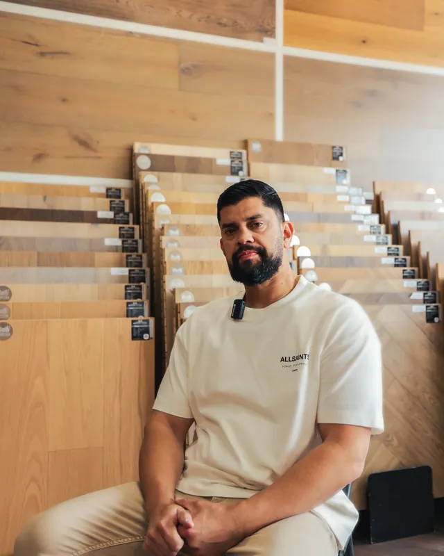 Alexander Parada in front of the wood sample racks