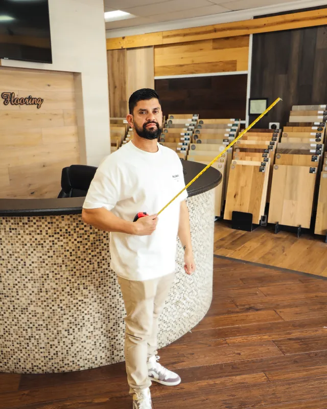 Alexander Parada measuring with a tape measure in the showroom