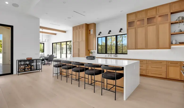 Open kitchen with a long island and wide-plank light-oak hardwood floor, a Glamour Flooring project