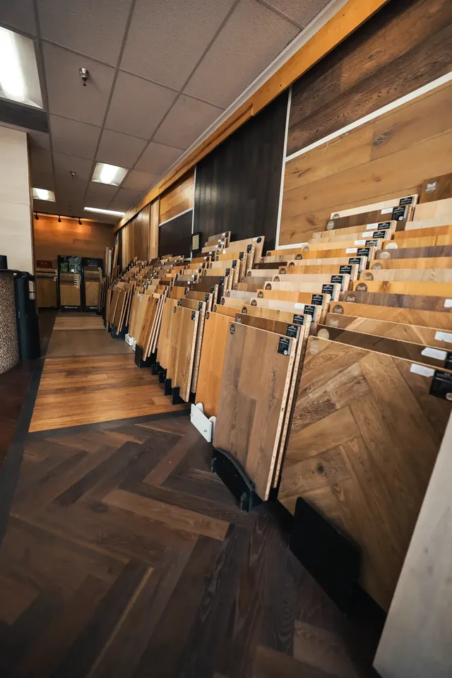 Hardwood sample racks over a herringbone floor in the Glamour Flooring showroom