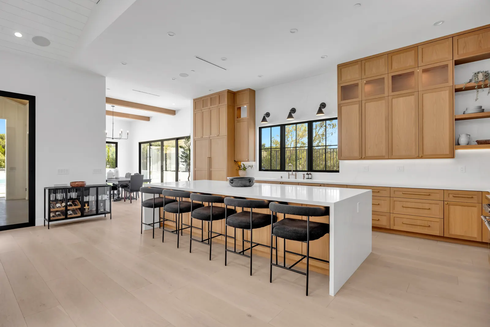 Kitchen with oak cabinetry, white waterfall island and light hardwood, Porter Ranch, Glamour Flooring project