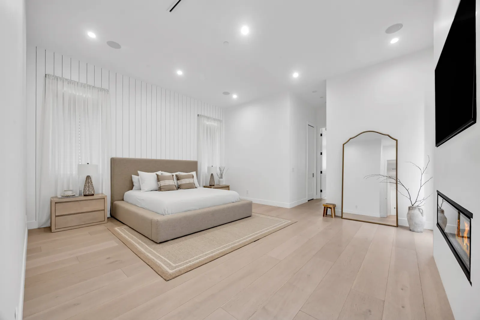 Bedroom with light wide-plank hardwood and fireplace, Porter Ranch, Glamour Flooring project