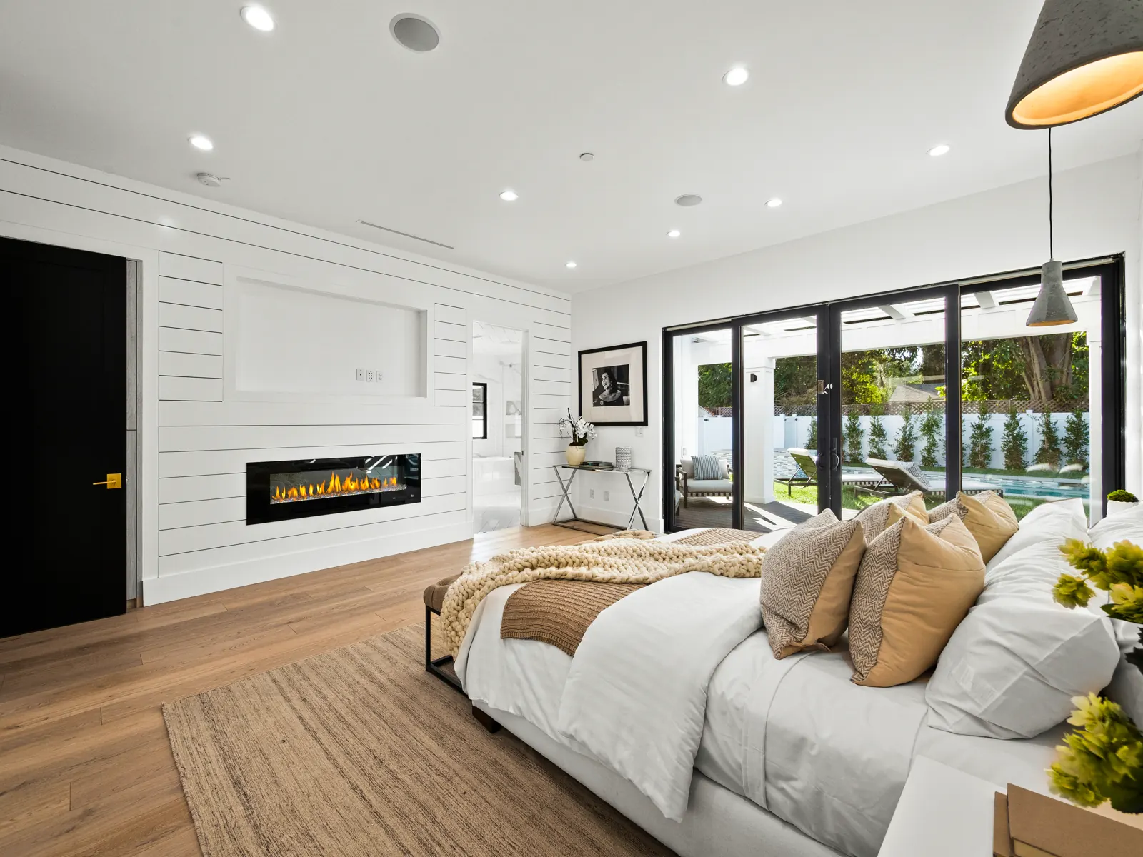 Bedroom with light hardwood and linear fireplace, Los Angeles, Glamour Flooring project