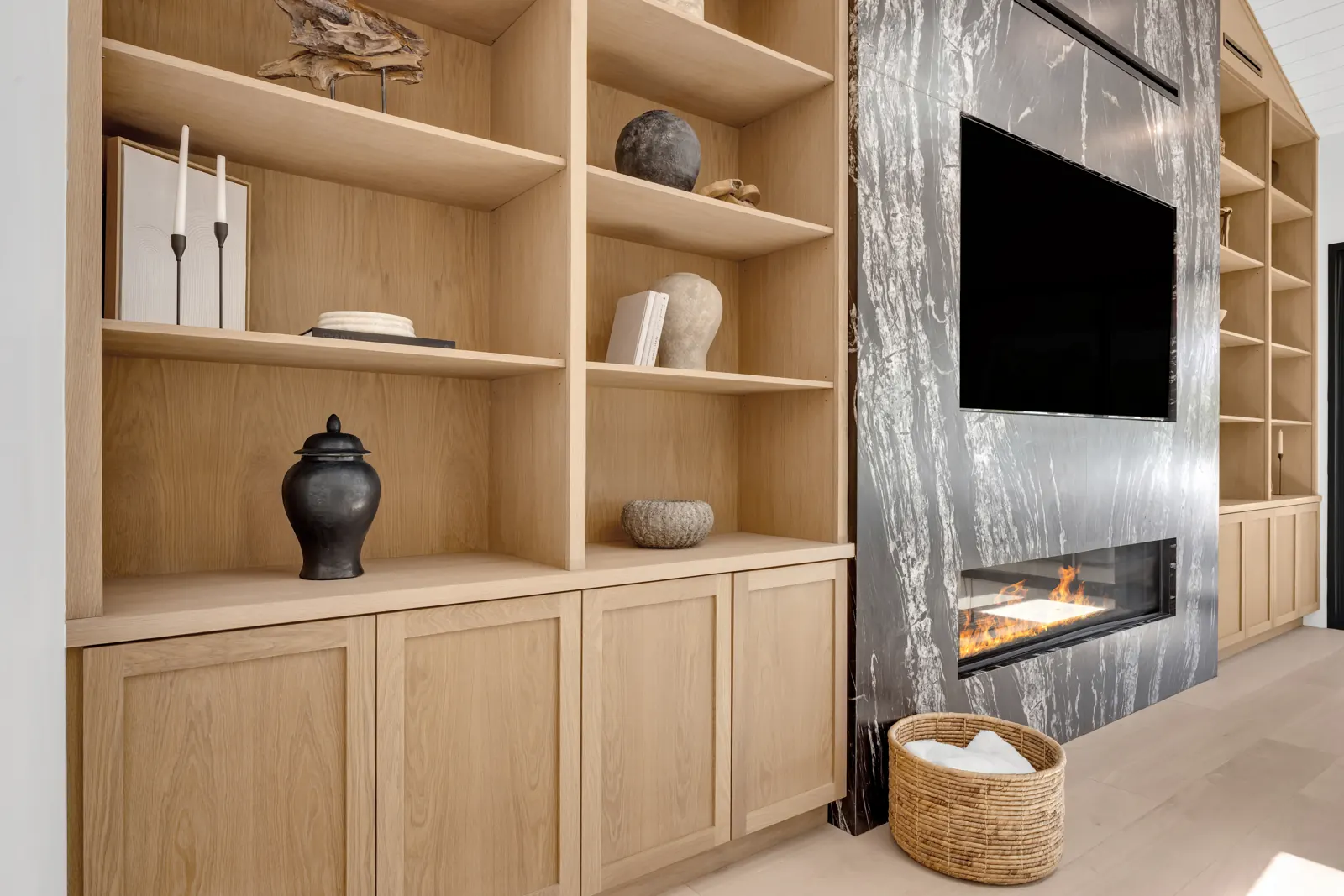 Oak built-in shelving beside a stone fireplace wall, Porter Ranch, Glamour Flooring project