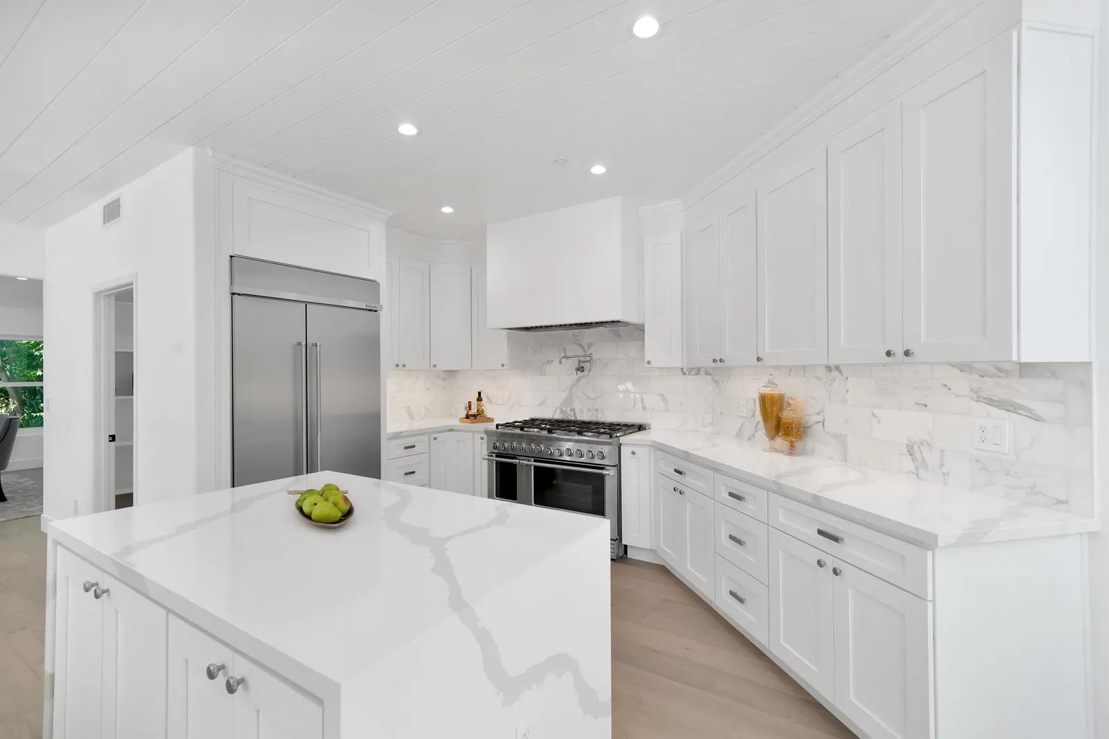 Kitchen with large marble island and stainless appliances, Granada Hills, Glamour Flooring project