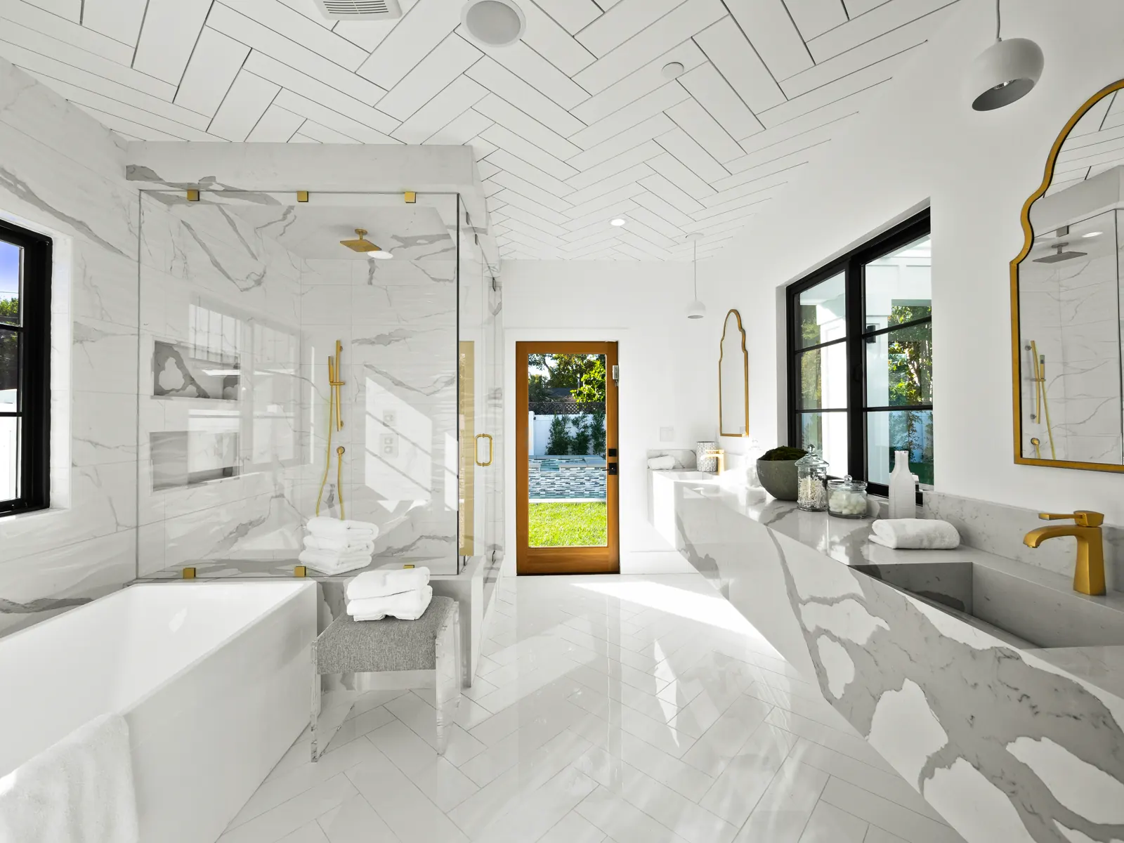 Primary bath with marble floors and glass shower, Los Angeles, Glamour Flooring project