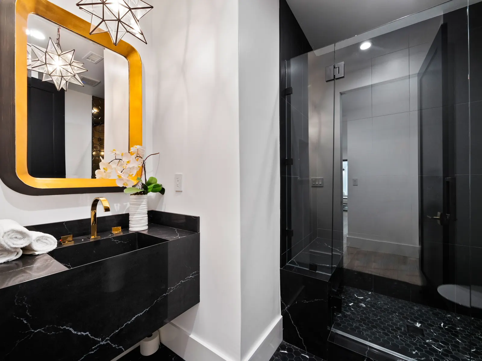 Powder room with black vanity and gold mirror, Los Angeles, Glamour Flooring project