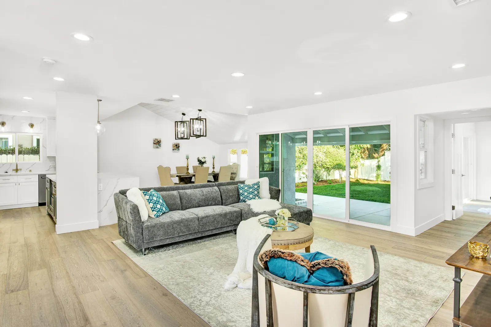 Open living room with light flooring and sliding doors, Sherman Oaks, Glamour Flooring project